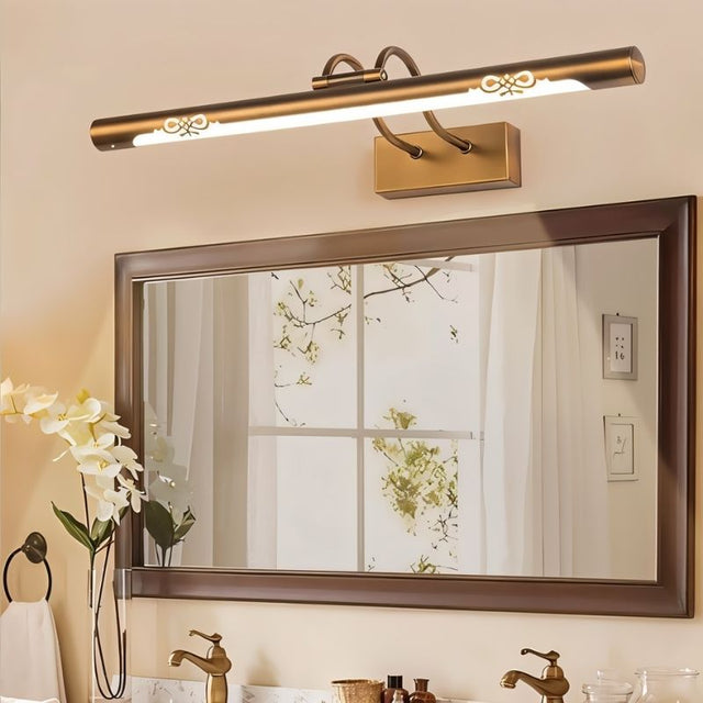 "A copper LED vanity light with decorative cutouts mounted above a bathroom mirror with a double sink."