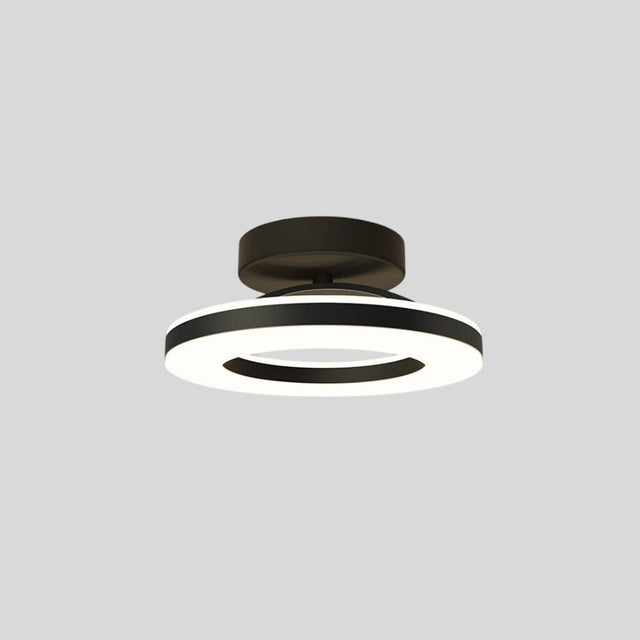 "Modern circular ceiling light with black dual-ring design, illuminated, isolated on a gray background."