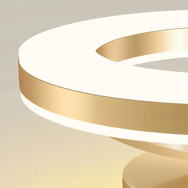 "Close-up detail of a modern ceiling light showing illuminated acrylic rings and gold band."