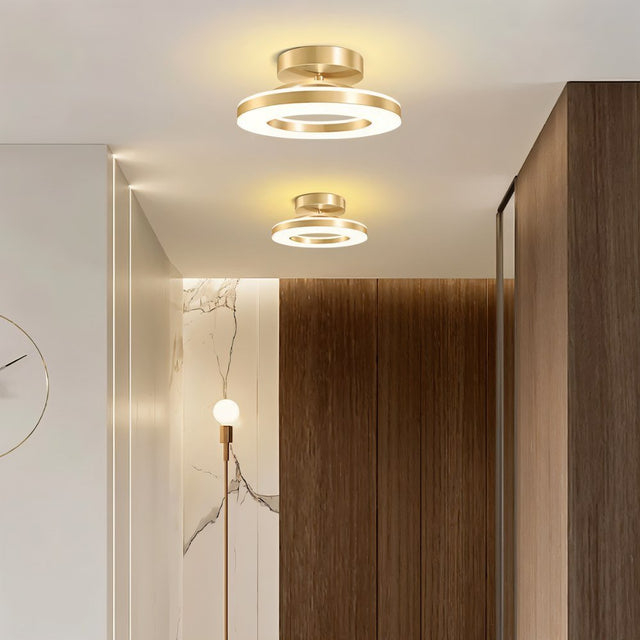 "Two modern circular ceiling lights with dual-ring design in a contemporary hallway."