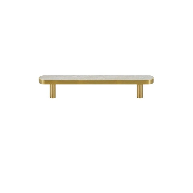 "A modern brass pull bar with a white shell inlay, isolated on a white background."