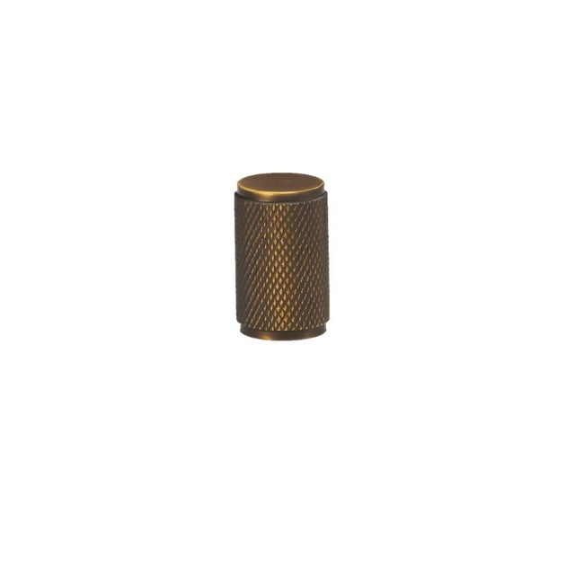 "Precision-crafted antique brass knurled cabinet knob with a cylindrical shape and sleek metallic finish."