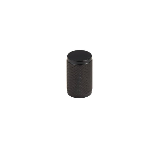 "A precision-crafted black brass knurled cabinet knob with a cylindrical shape and sleek metallic finish."