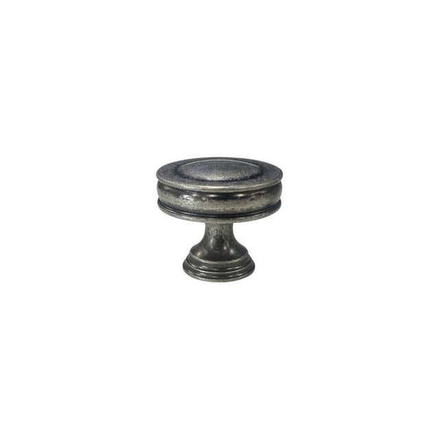 "Front view of a vintage-inspired brass knob with layered ridges and a distressed finish."