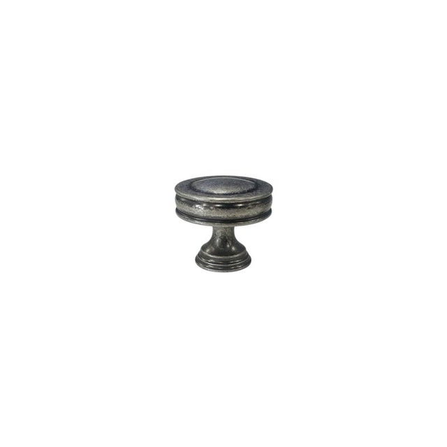 "A vintage-inspired brass knob with layered ridges and a distressed finish, isolated on a white background."