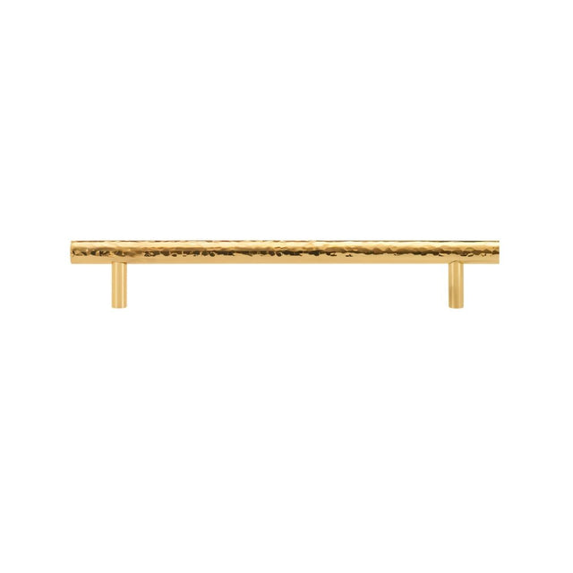 "A hammered brass pull bar with a textured, artisanal design, suitable for cabinetry and doors."