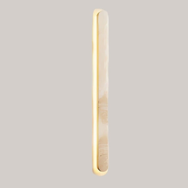 "Close-up of the natural travertine texture on a modern wall light"