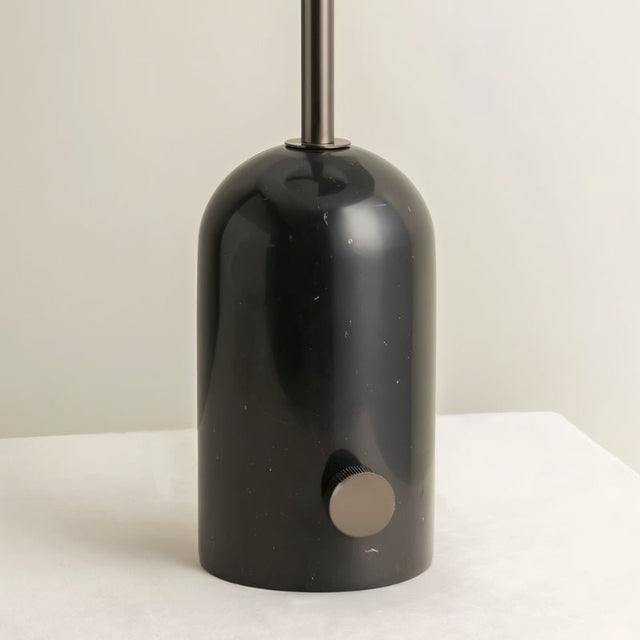 "Close-up of black marble base with metal accents, polished and sturdy design, modern and minimalist lighting"