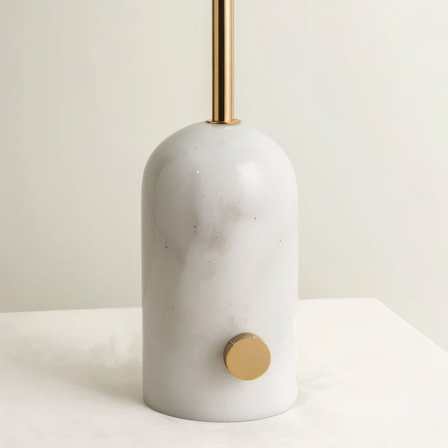 "Close-up of white marble base with brass accents, smooth and sturdy construction, modern and minimalist design"