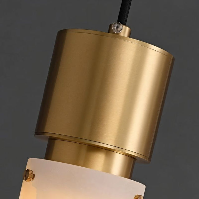 "Close-up of a modern pendant light showing the copper-accented frame and alabaster shade."