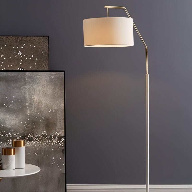 "White and gold iron floor lamp with a fabric drum shade, adding soft, diffused lighting and modern style to contemporary living spaces."