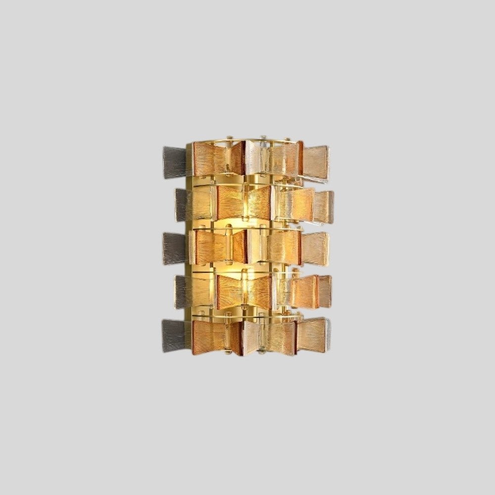 "Isolated iron Salane wall lamp with layered amber glass panels and visible light glow, on a light grey background."