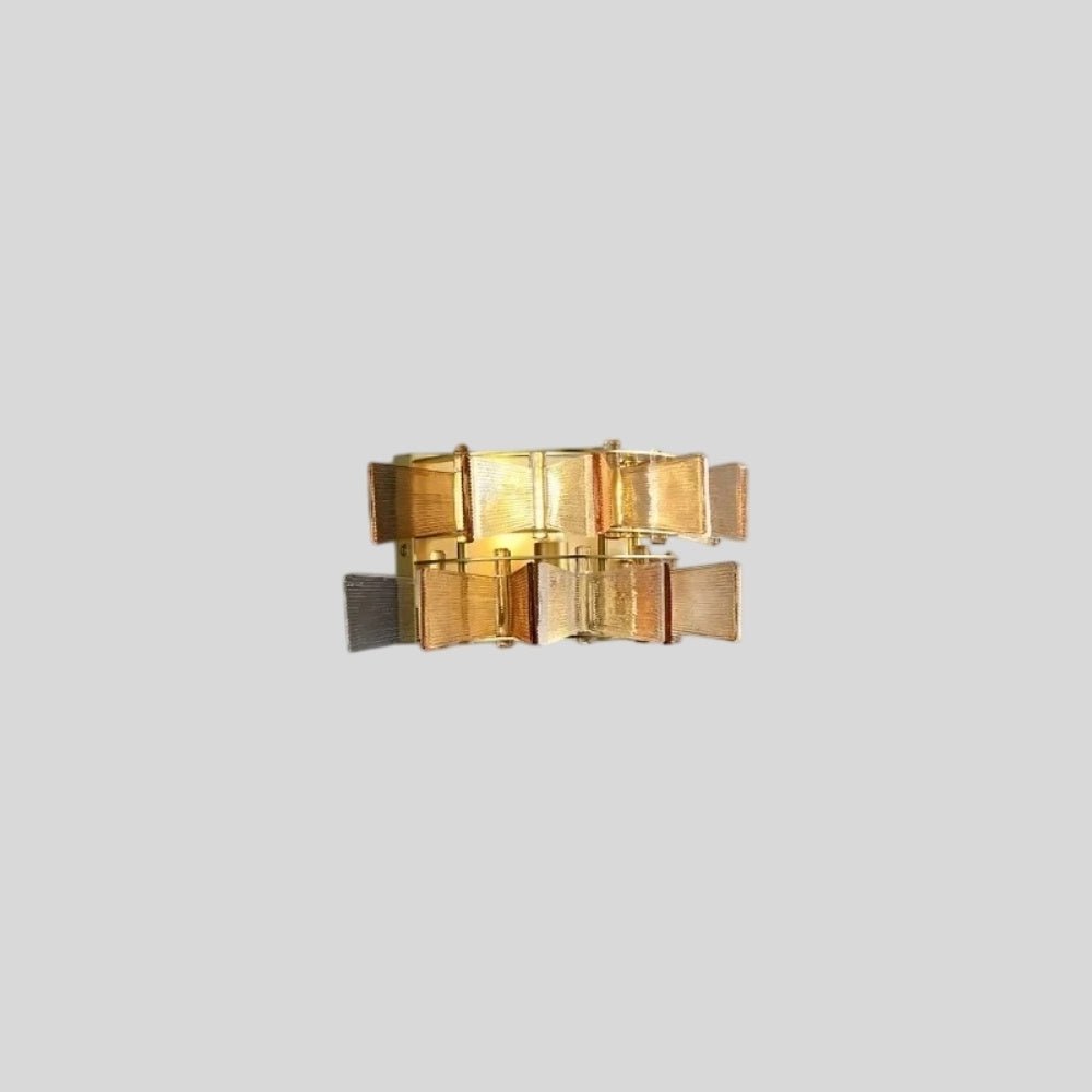 "Isolated iron Salane wall lamp with layered amber glass panels on a light grey background."