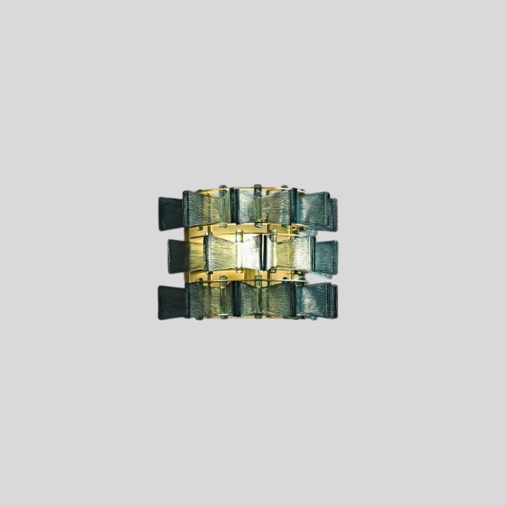 "Isolated iron Salane wall lamp with layered blue glass panels on a light grey background, centered view."