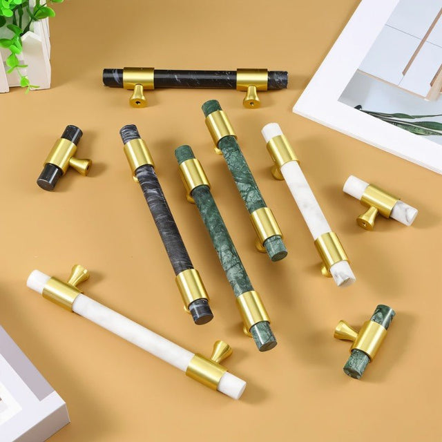 "Assortment of luxurious marble handles with polished brass accents, showcasing various colors and designs for contemporary and classic interiors."