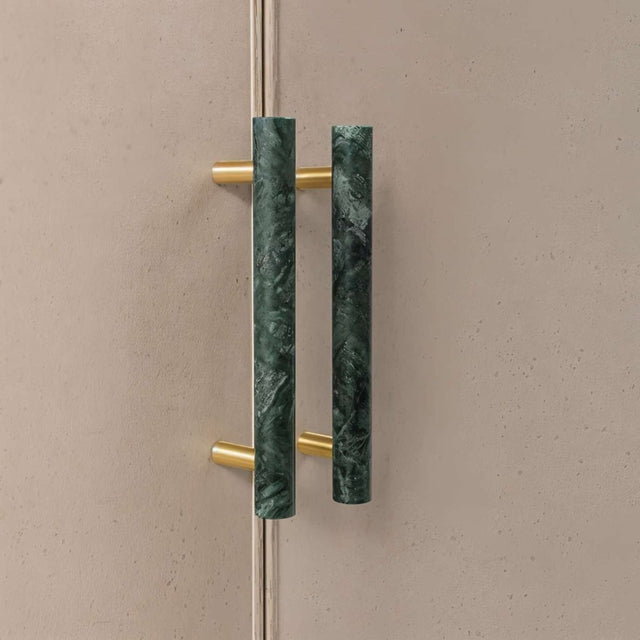 "A green marble knob with a polished brass stem, suitable for cabinets and drawers."