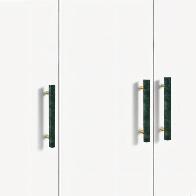 "Modern green marble and brass pull bars on a minimalist white cabinet, showcasing elegant hardware."