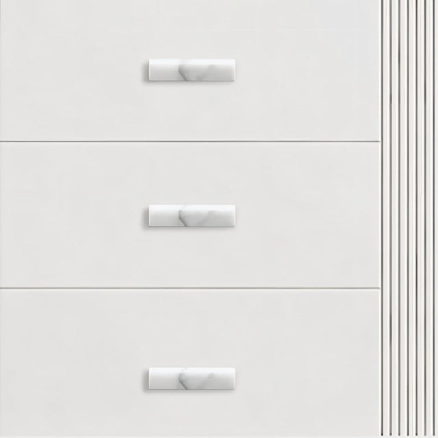 "Contemporary white drawers with sleek marble knobs, showcasing elegant hardware on furniture."