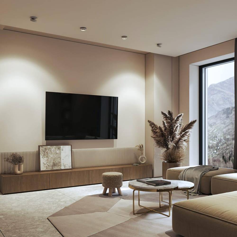 Recessed ceiling downlight in brushed nickel finish installed in a modern living room with neutral tones and mountain views.
