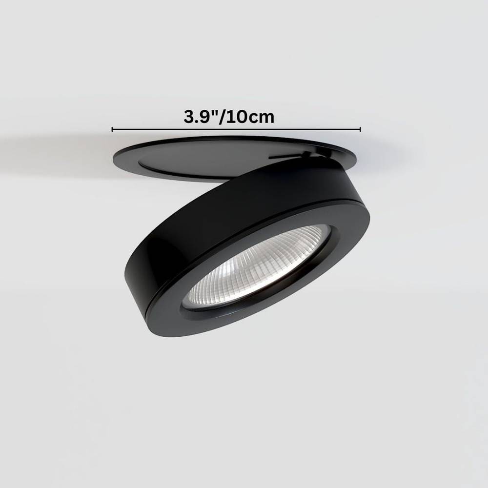 Black adjustable downlight fixture with ribbed lens shown installed in ceiling, 3.9 inches diameter.