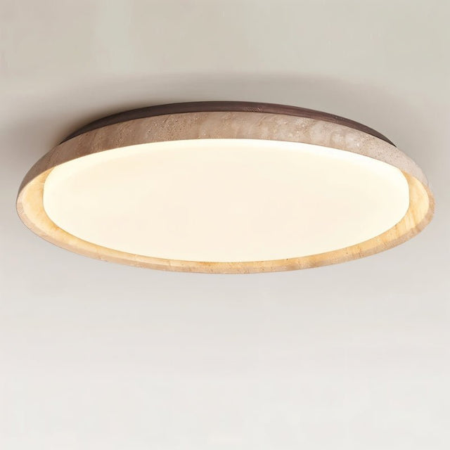 "Close-up of a minimalist ceiling light with a soft yellow travertine ring and acrylic diffuser, emitting a soft, even glow."