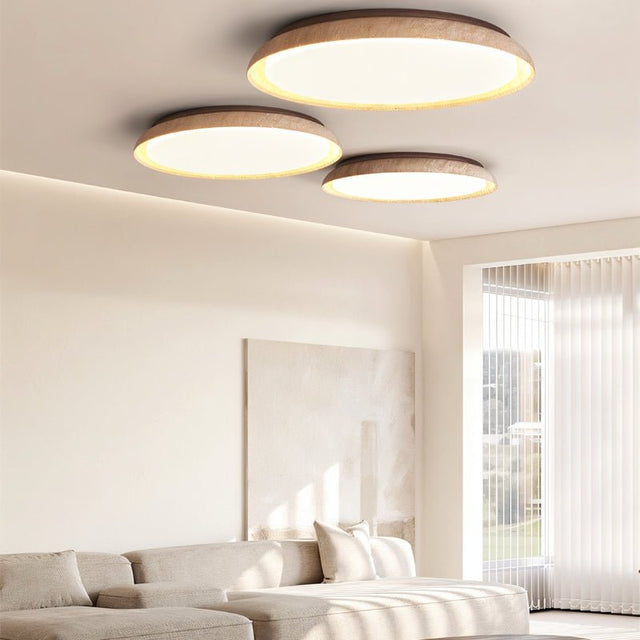 "Multiple minimalist ceiling lights with soft yellow travertine rings and acrylic diffusers, creating a warm and inviting ambiance in a contemporary living room."