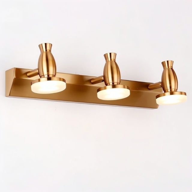 "A modern, 3-head vanity light in a brushed gold finish, showcasing its sleek design."
