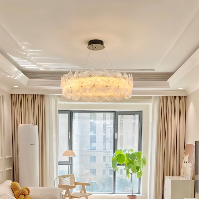 "A ring chandelier with handcrafted glass petals in a living room."