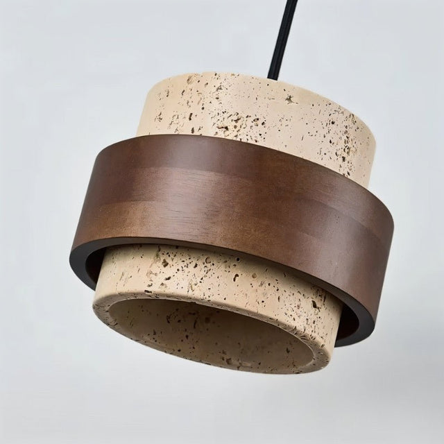 "Close-up of a modern cylindrical pendant light featuring natural stone and dark wood, showcasing the texture and detail."