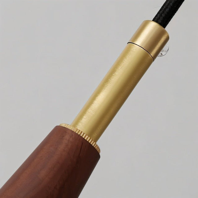 "Close-up of a modern pendant light showing the wood and copper detailing."