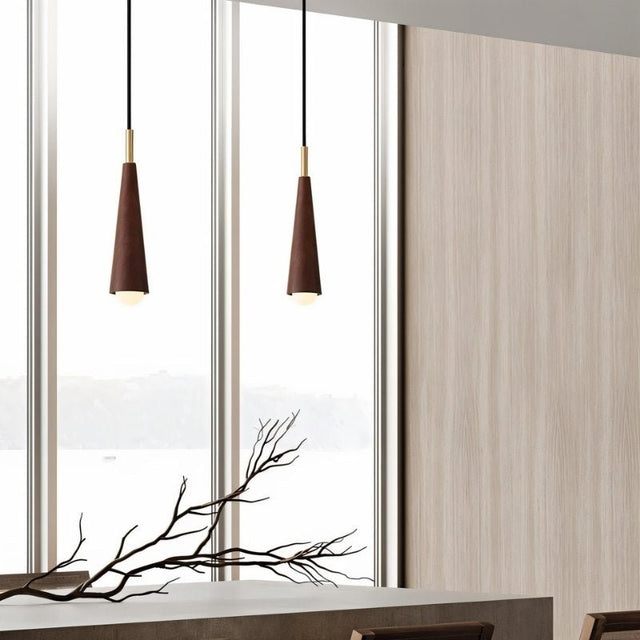 "Minimalist pendant lights with sleek wooden shades and copper accents hang in a modern space."