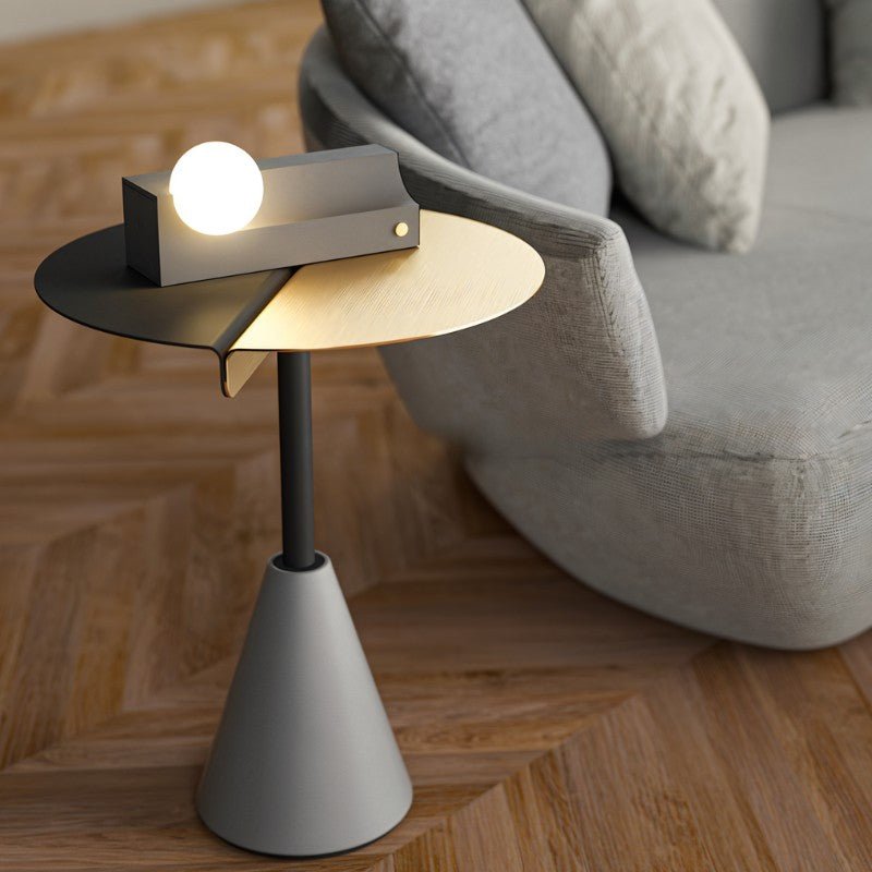 Compact Teral Table Lamp on designer side table beside sofa, ideal for stylish and functional bedroom or living room lighting.