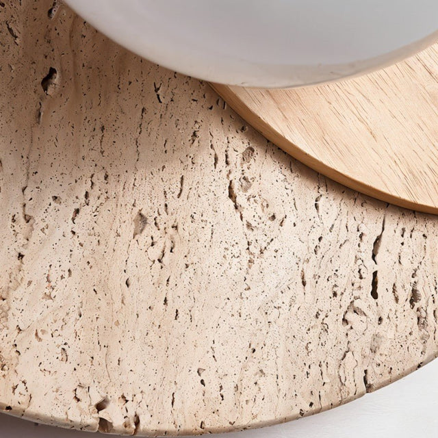 "Close-up of a wabi-sabi wall lamp featuring travertine and wood, showcasing the natural texture and organic details of the materials."