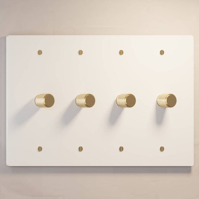 Four-gang The Brass Dimmer Switch - Open Box in white with brass knobs, perfect for luxury lighting systems.