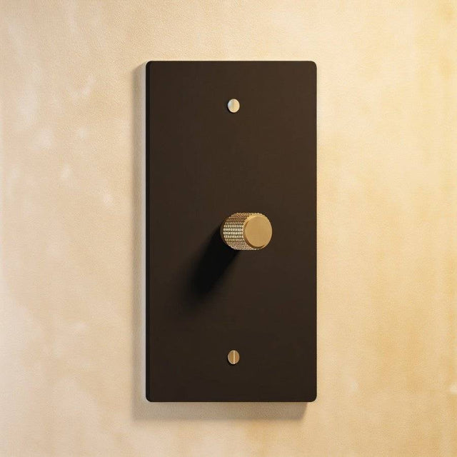 Single gang The Brass Dimmer Switch - Open Box in matte black with brass knob, blending modern and classic aesthetics.