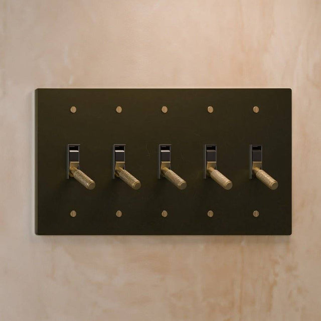 Five-gang The Brass Toggle Switch (1 to 5 Gang) - Open Box in matte black with brass toggles, ideal for expansive lighting control in designer homes.