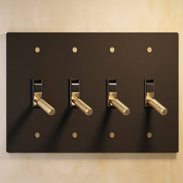 Four-gang The Brass Toggle Switch (1 to 5 Gang) - Open Box in black with gold toggles, perfect for high-end lighting installations.