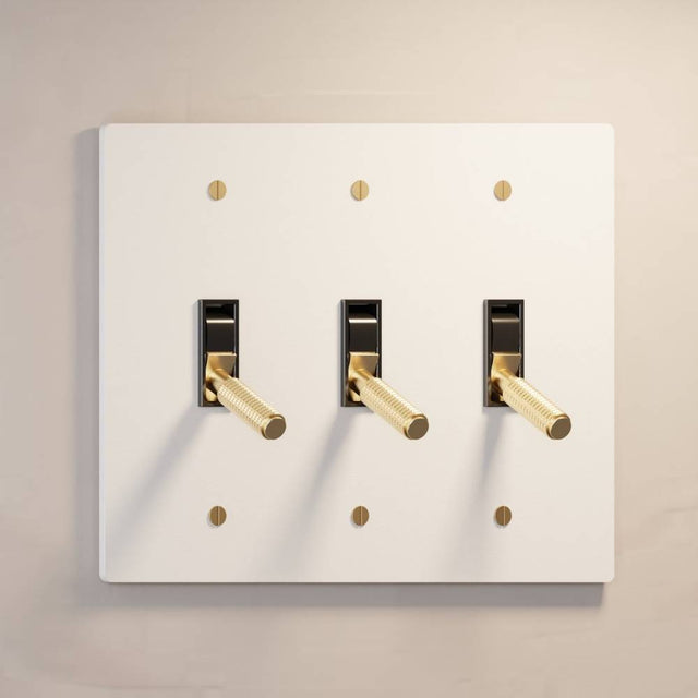 Triple gang The Brass Toggle Switch (1 to 5 Gang) - Open Box in matte white with brass toggles, offering elegant lighting control.
