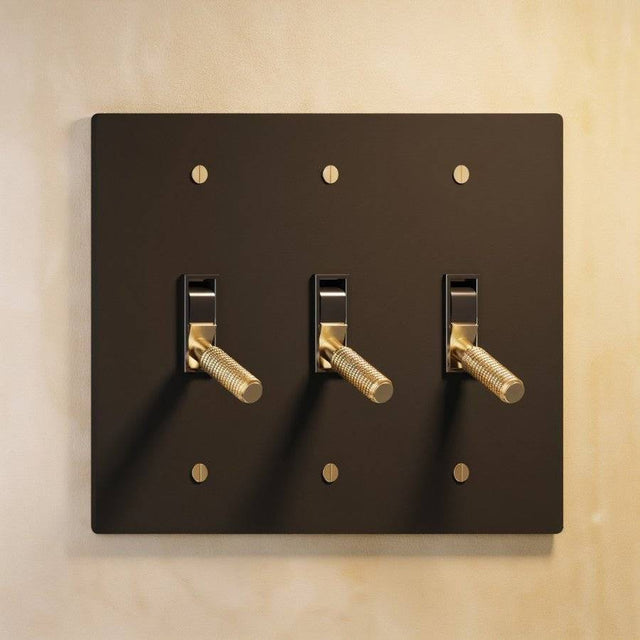Triple gang The Brass Toggle Switch (1 to 5 Gang) - Open Box in matte black with brass toggles, offering stylish control for modern interiors.