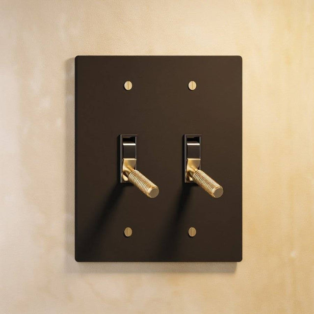 Double gang The Brass Toggle Switch (1 to 5 Gang) - Open Box in black with gold toggles, ideal for bold, contemporary lighting schemes.