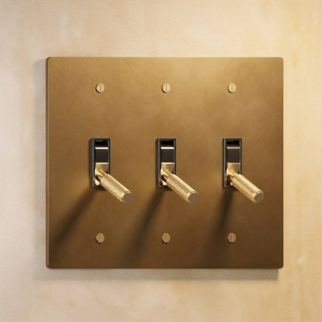 Three-gang The Brass Toggle Switch (1 to 5 Gang) - Open Box in polished brass finish, offering premium tactile lighting control for upscale interiors.