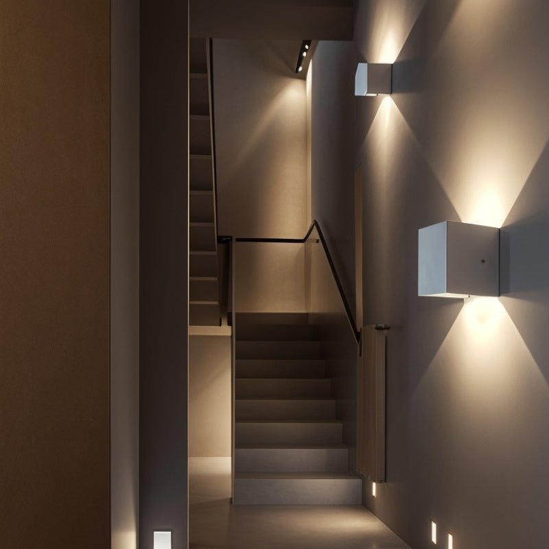 "Tine Wall Lamp installed in a hallway, enhancing the modern minimalist design with upward and downward light beams, crafted from gypsum and aluminum."