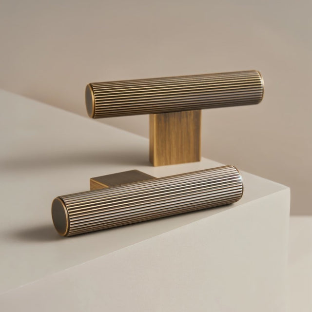 "Pair of modern brass pull bars with a sleek ribbed texture, ideal for cabinet doors, drawers, and wardrobe panels in modern and transitional interiors."