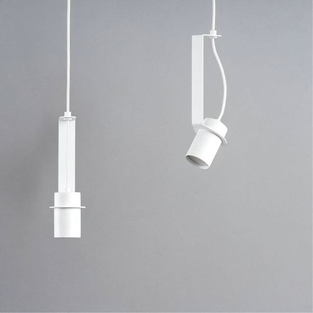 "Two white pendant lights, one straight and one oblique, showing their different orientations and minimalist design."