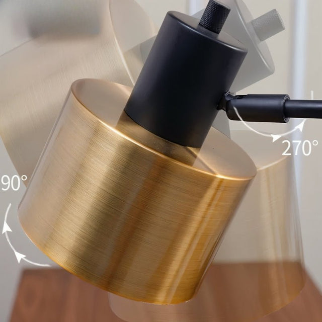 "Close-up of the rotatable brass head of the table lamp, showing a 270° adjustable angle for focused illumination"