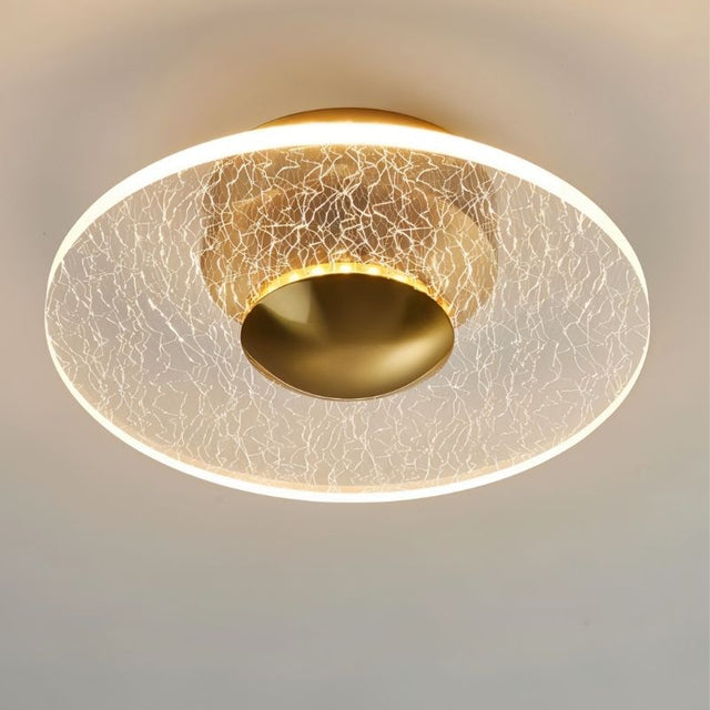 "A disc-shaped ceiling light with a cracked-glass effect diffuser, providing ambient illumination."