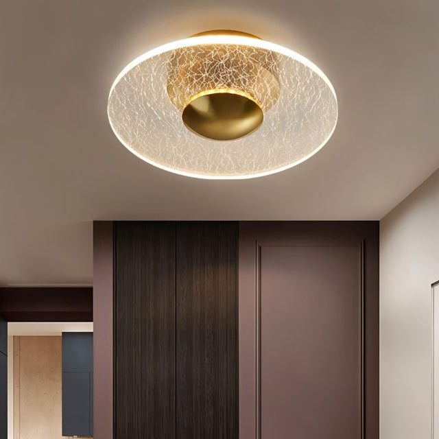 "A modern ceiling light with a cracked-glass effect diffuser, providing soft ambient lighting in a contemporary space."