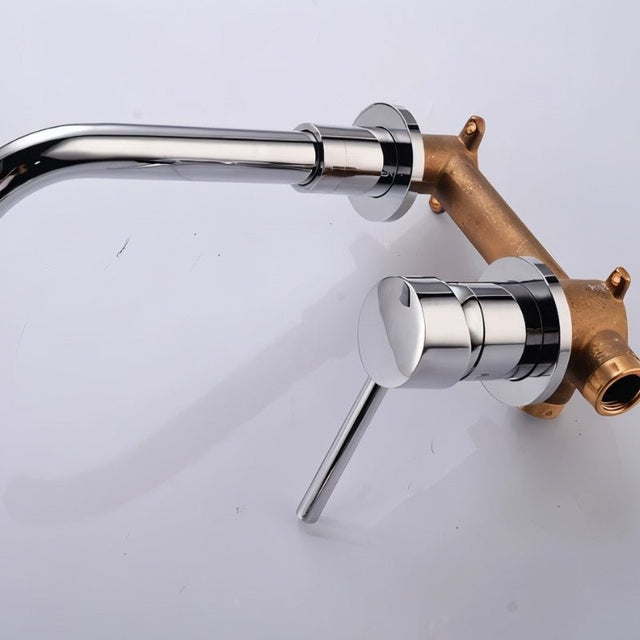 Chrome Vartay Bathroom Faucet with exposed brass plumbing, showing internal wall-mounted installation components.
