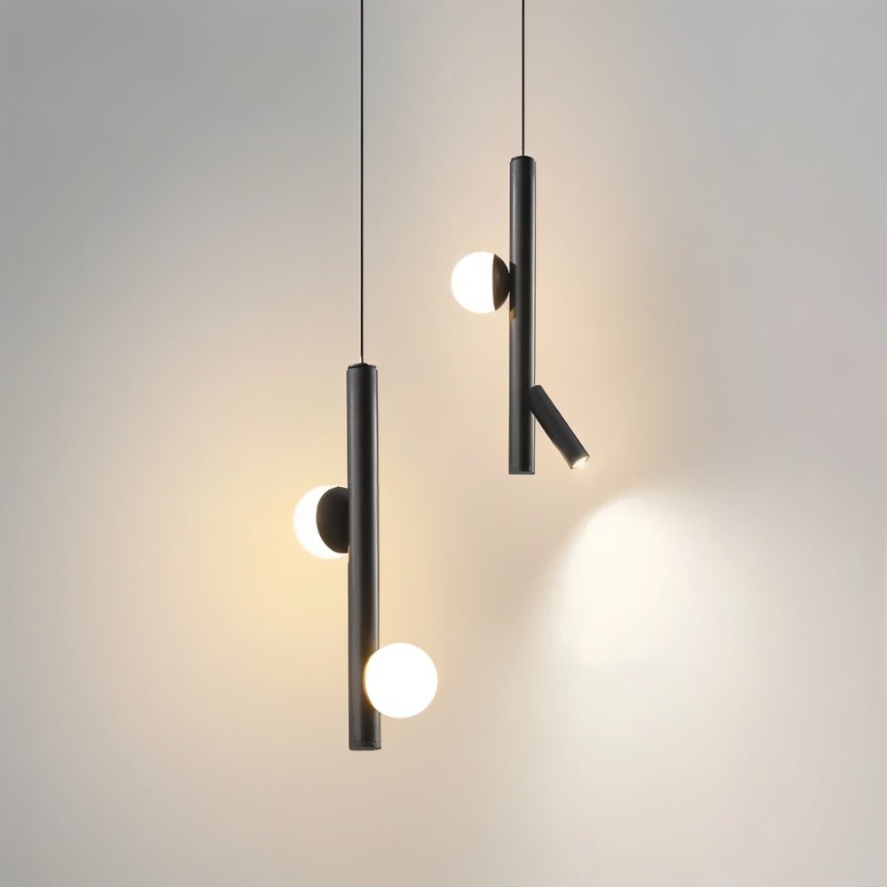 "Two sleek, iron and acrylic pendant lights with cylindrical rods and glowing orb accents, hanging against a light background."