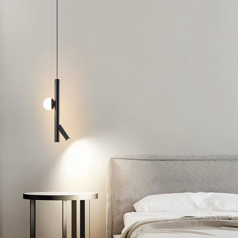 "A sleek, iron and acrylic pendant light with cylindrical rods and a glowing orb accent hangs above a modern side table and bed in a minimalist bedroom."
